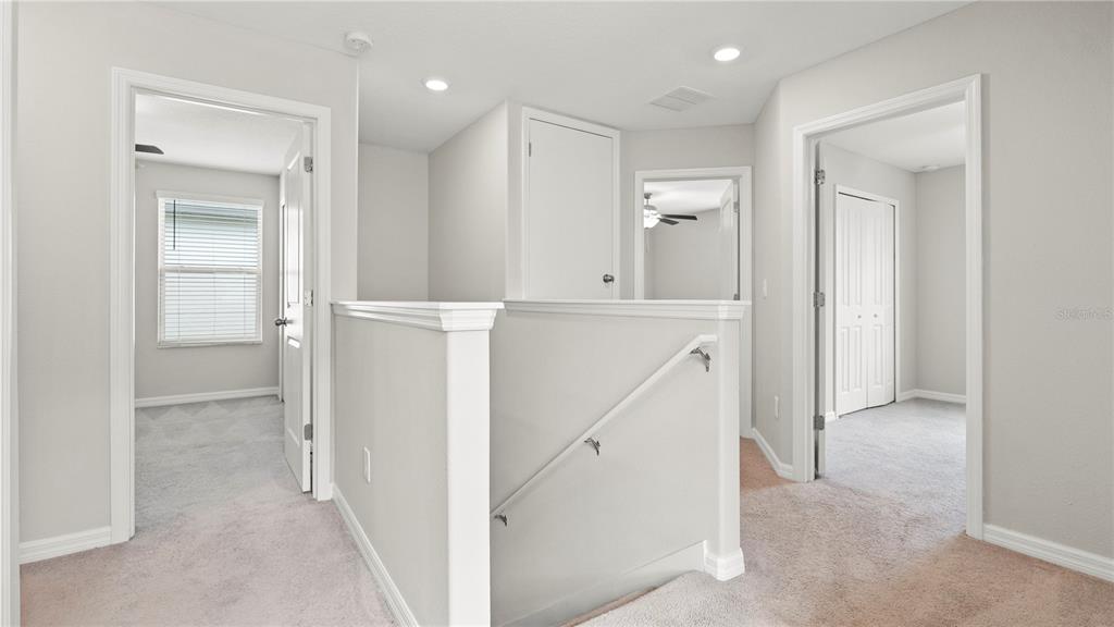 7231 Spring Snowflake Avenue Tampa, FL 33619 - Photo 22 of 46 hallway with white cabinets and wooden floor
