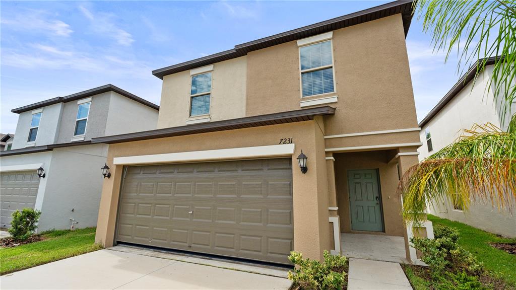7231 Spring Snowflake Avenue Tampa, FL 33619 - Photo 3 of 46 a front view of a house with a garage