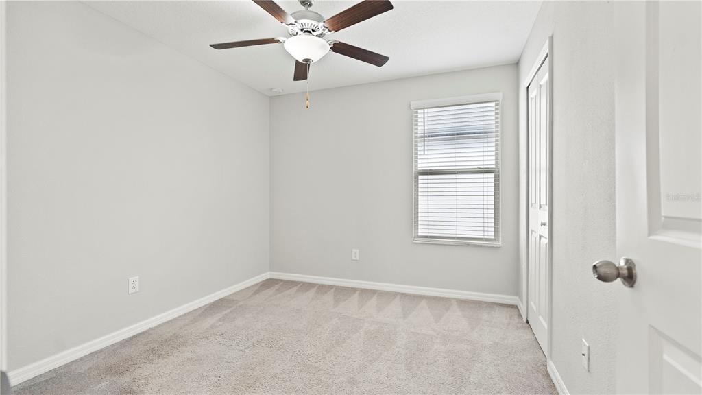 7231 Spring Snowflake Avenue Tampa, FL 33619 - Photo 32 of 46 an empty room with windows and fan