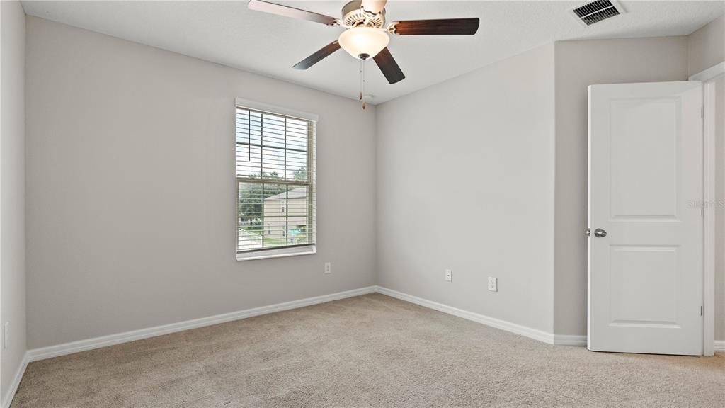 7231 Spring Snowflake Avenue Tampa, FL 33619 - Photo 35 of 46 an empty room with windows and fan