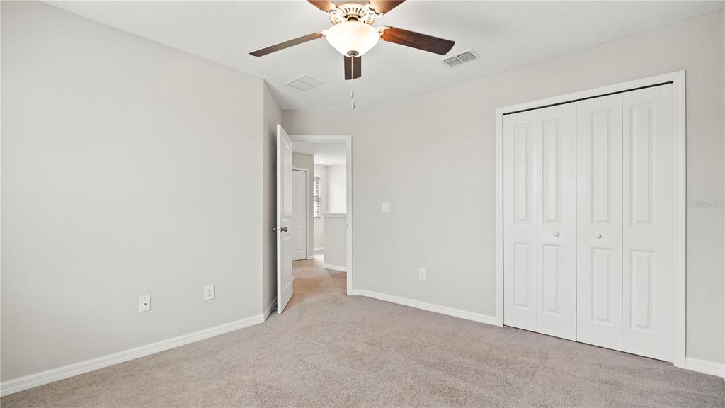 7231 Spring Snowflake Avenue Tampa, FL 33619 - Photo 36 of 46 an empty room with fan and entrance