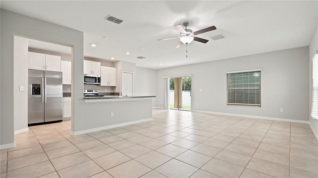7231 Spring Snowflake Avenue Tampa, FL 33619 - Photo 6 of 46 a view of kitchen with stainless steel appliances cabinets and window