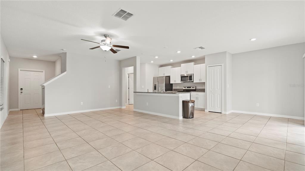 7231 Spring Snowflake Avenue Tampa, FL 33619 - Photo 7 of 46 a kitchen with kitchen island granite countertop appliances cabinets and a sink