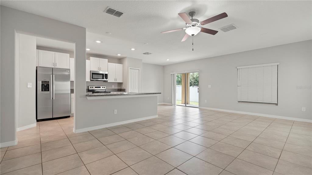 7231 Spring Snowflake Avenue Tampa, FL 33619 - Photo 9 of 46 a view of a kitchen with a sink and a refrigerator