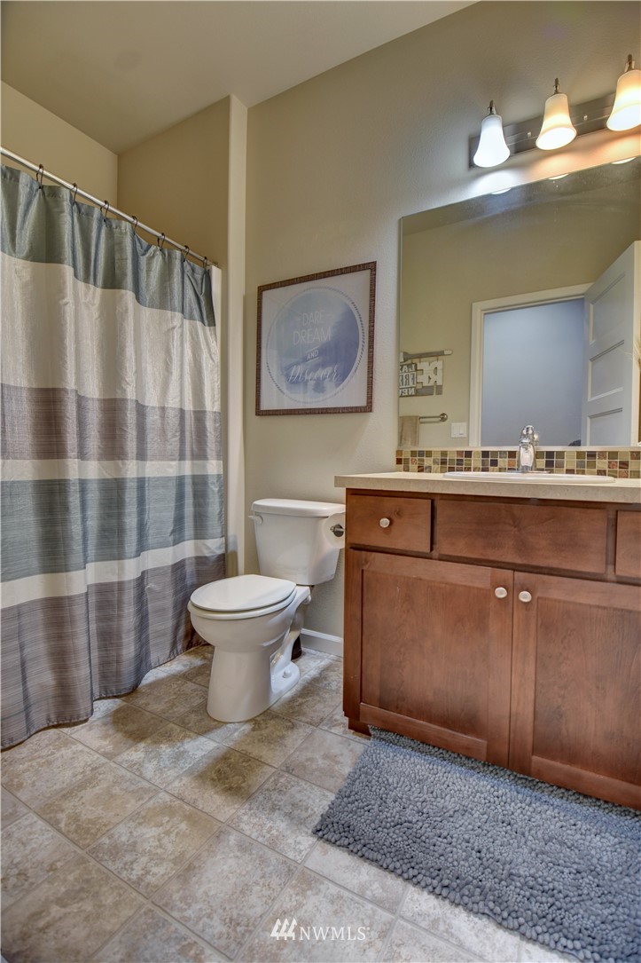 4835 Rosa Court Lacey, WA 98503 - Photo 15 of 40 a living room with a sink and a mirror