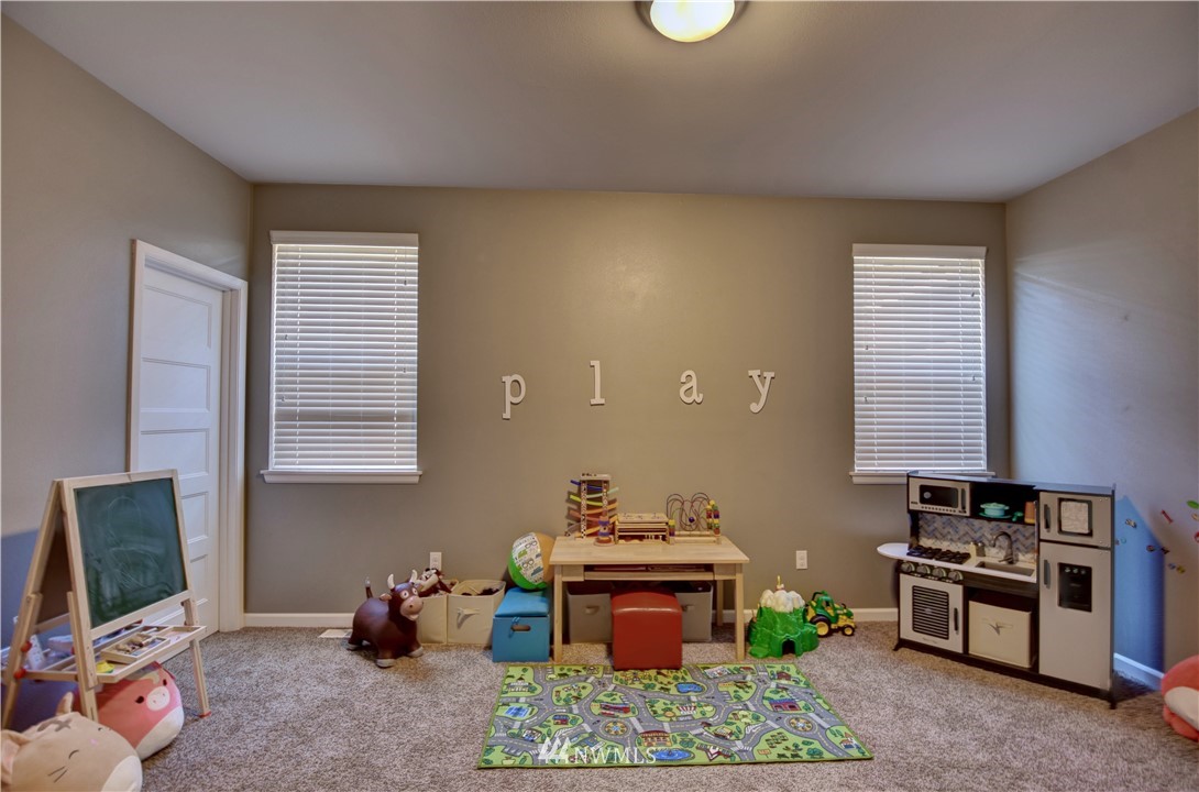 4835 Rosa Court Lacey, WA 98503 - Photo 16 of 40 a room with furniture and a flat screen tv