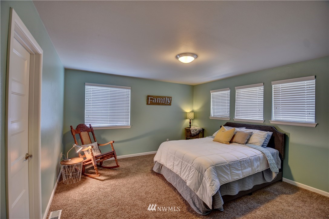 4835 Rosa Court Lacey, WA 98503 - Photo 23 of 40 a bedroom with a bed a table and chair