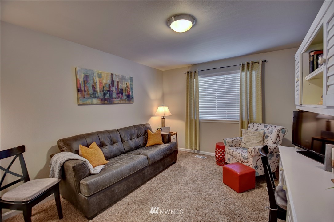 4835 Rosa Court Lacey, WA 98503 - Photo 24 of 40 a living room with furniture flat screen tv and a window