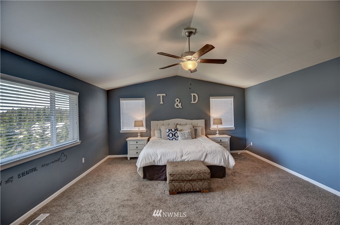 4835 Rosa Court Lacey, WA 98503 - Photo 28 of 40 a bedroom with a large bed and a large window