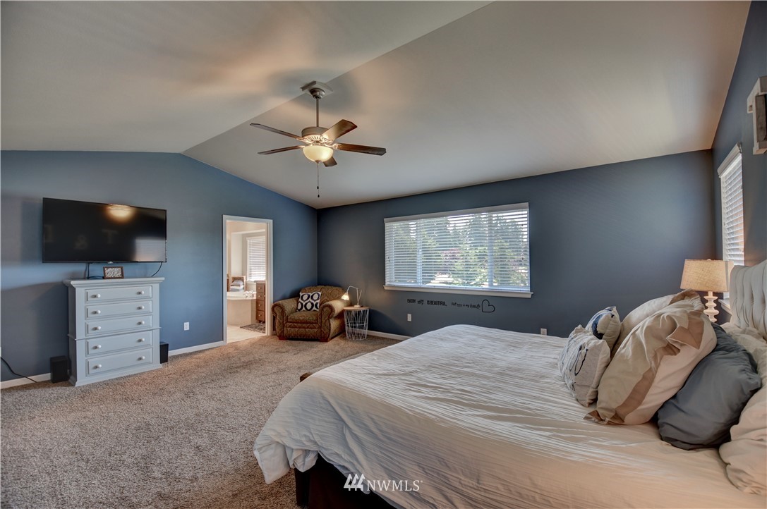4835 Rosa Court Lacey, WA 98503 - Photo 29 of 40 a bedroom with a bed and a flat screen tv