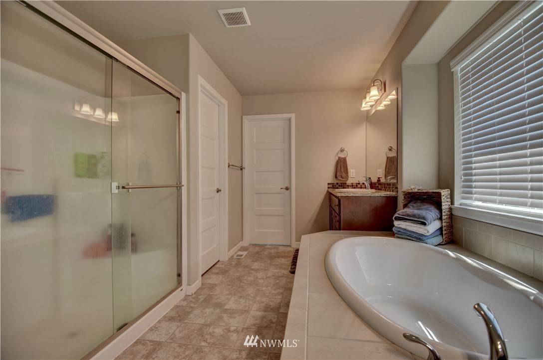4835 Rosa Court Lacey, WA 98503 - Photo 31 of 40 a en suite bathroom with a granite countertop tub sink and shower