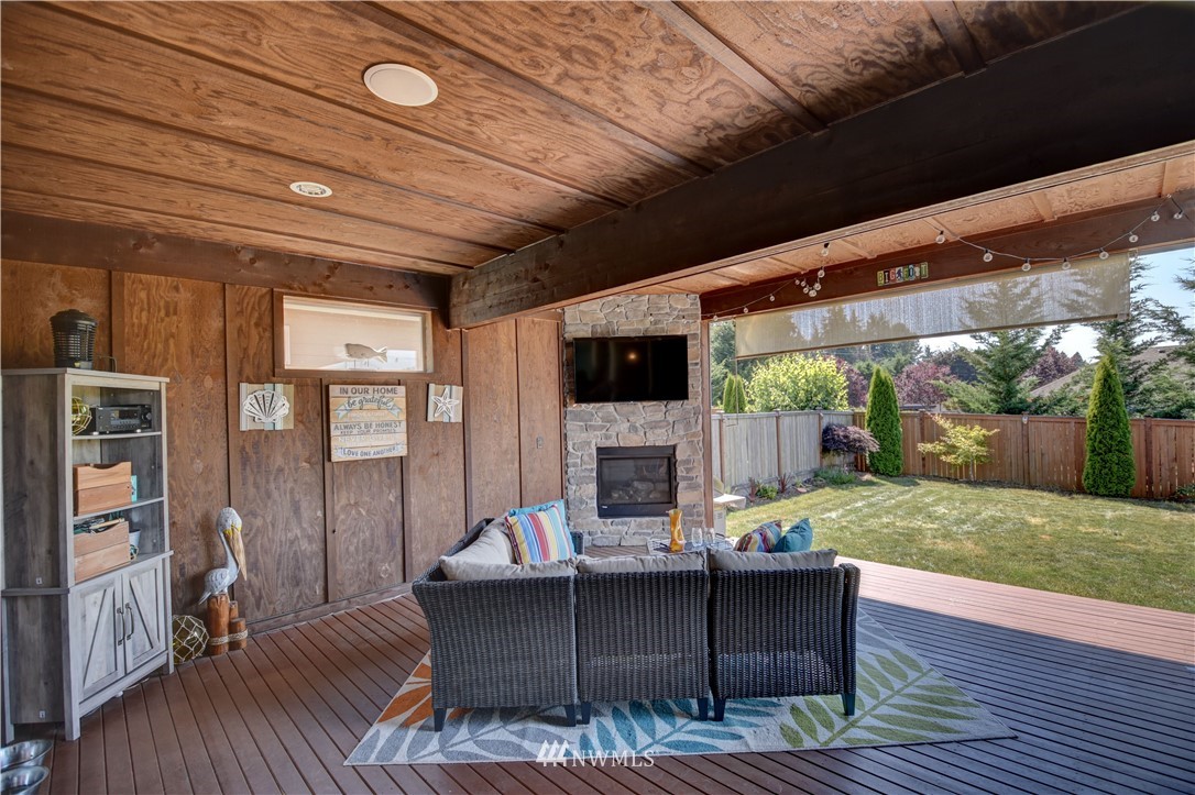 4835 Rosa Court Lacey, WA 98503 - Photo 32 of 40 a living room with furniture floor to ceiling window and wooden floor