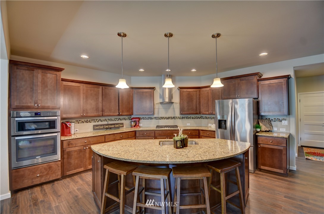 4835 Rosa Court Lacey, WA 98503 - Photo 9 of 40 a kitchen with a kitchen island and stainless steel appliances