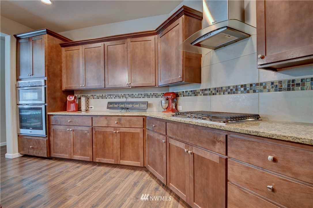 4835 Rosa Court Lacey, WA 98503 - Photo 10 of 40 a kitchen with stainless steel appliances granite countertop a stove a sink and a refrigerator