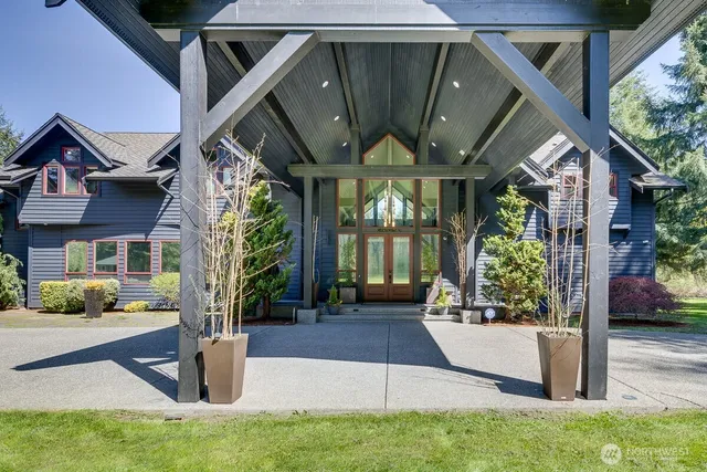 a view of a house with brick walls and floor to ceiling windows