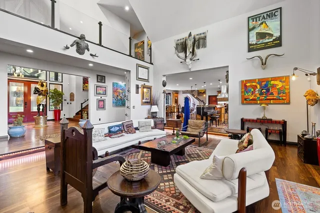 a living room with furniture kitchen view and a large window