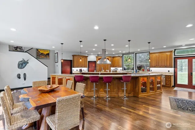 a living room with dining room and wooden floor