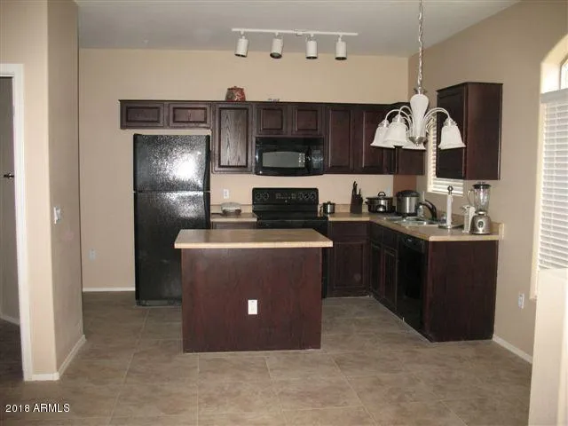 a kitchen with a refrigerator and a sink