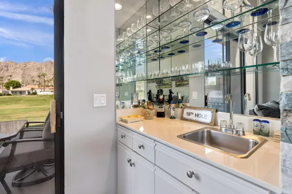 a kitchen with white cabinets a sink and appliances