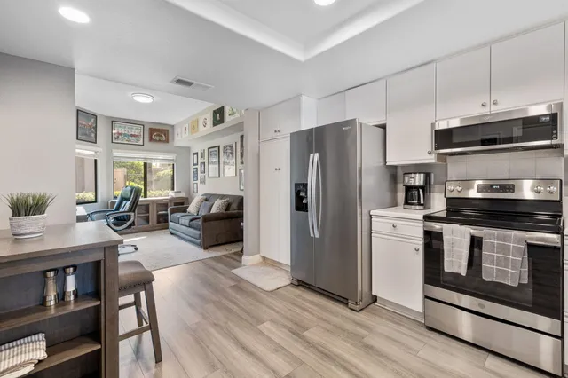 a view of a livingroom with workspace and a couch