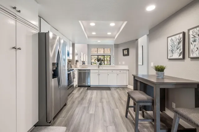 a large bed sitting in a bedroom next to a window