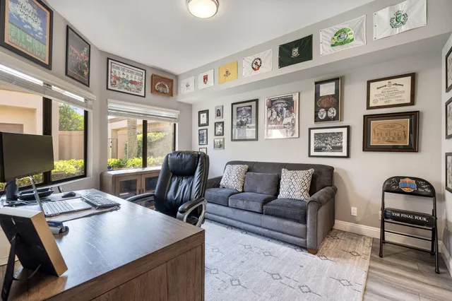 a bedroom with a large bed and a flat tv screen on dresser