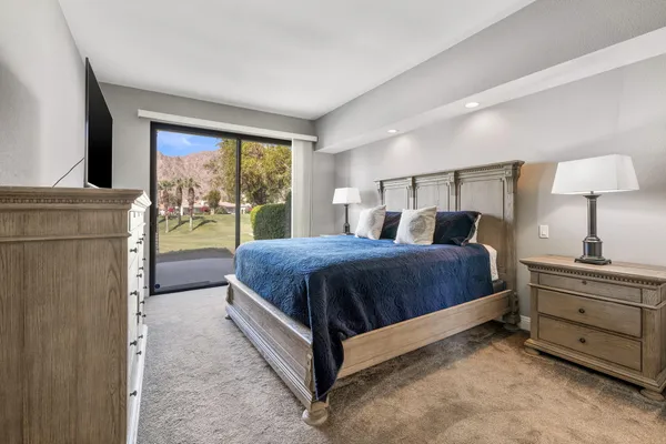 a view of a house with swimming pool and sitting area