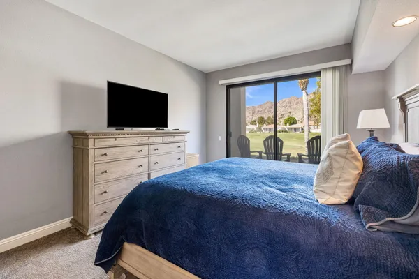 a view of a chairs and table in patio with a lake view