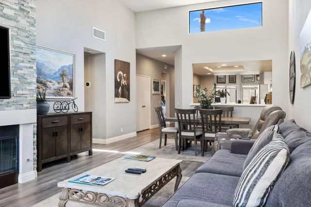 a living room with furniture and a floor to ceiling window