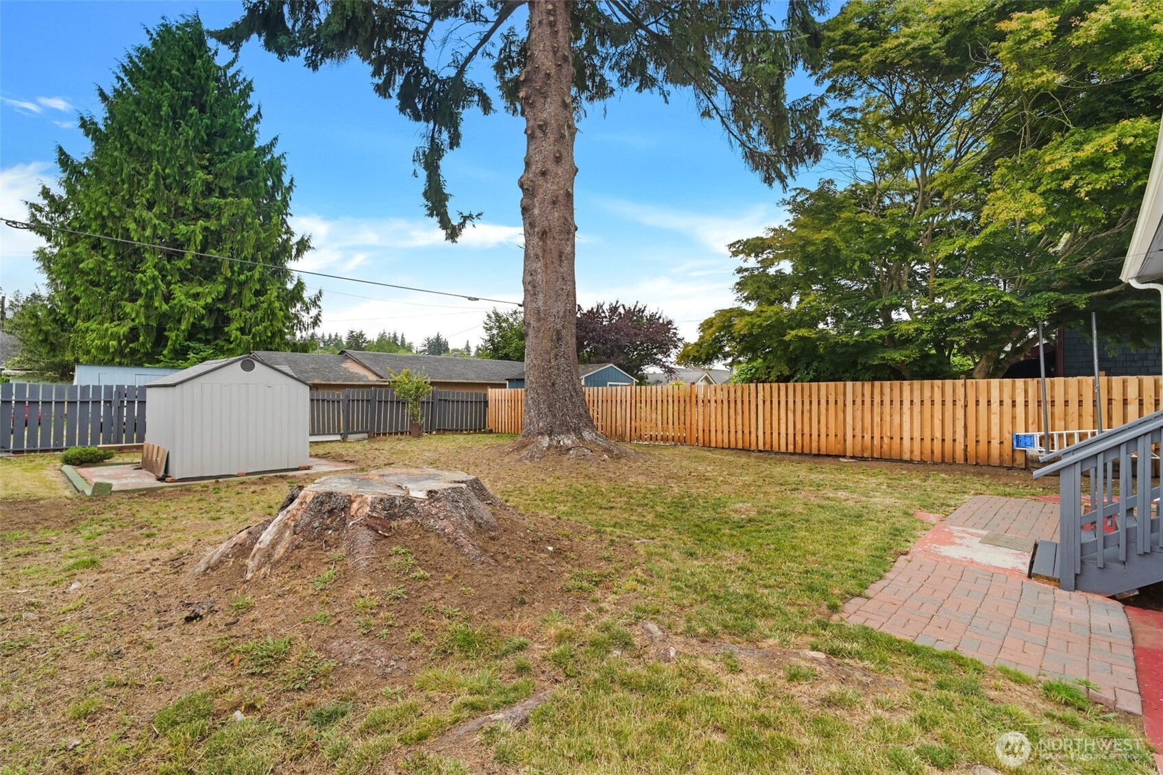 1224 4th Street Cosmopolis, WA 98537 - Photo 19 of 25 a backyard of a house with table and chairs plants and trees