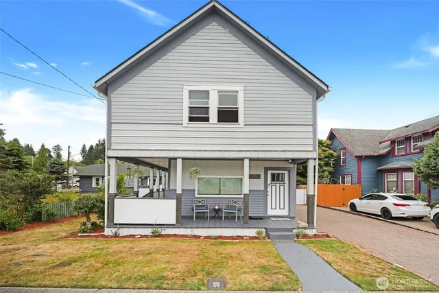 a front view of a house with a yard table and chairs