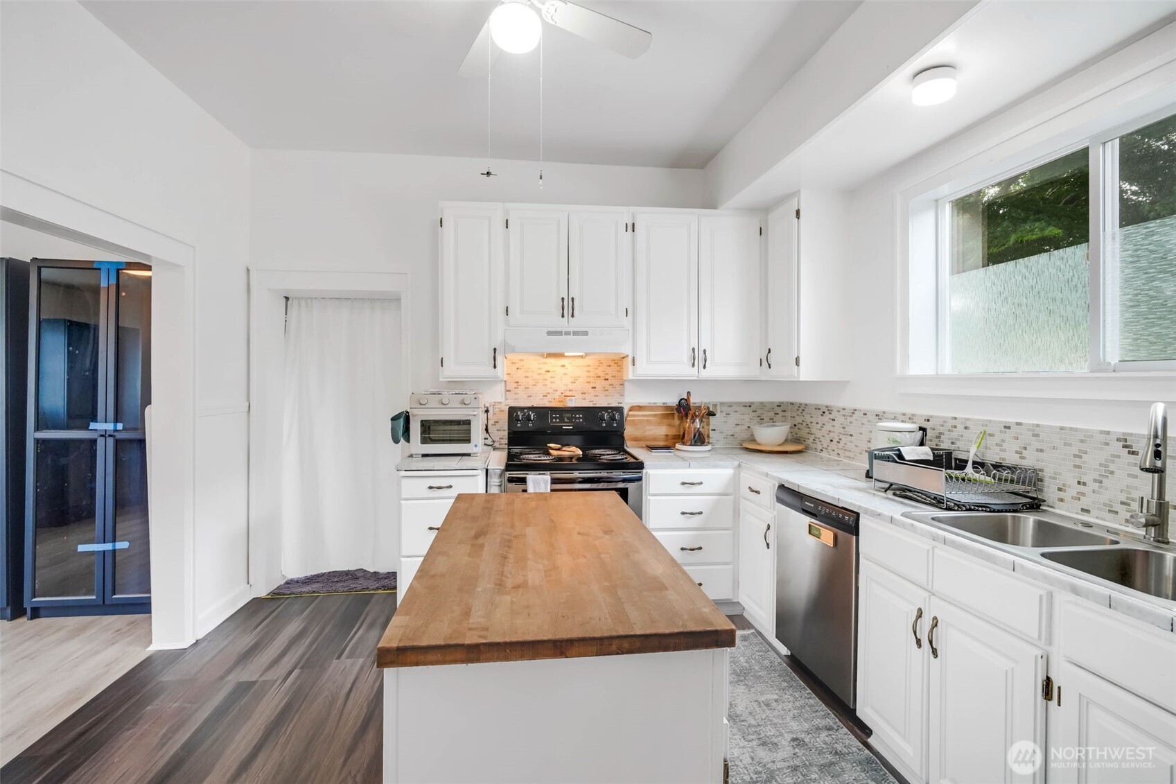1224 4th Street Cosmopolis, WA 98537 - Photo 7 of 25 a kitchen with wooden cabinets and white appliances
