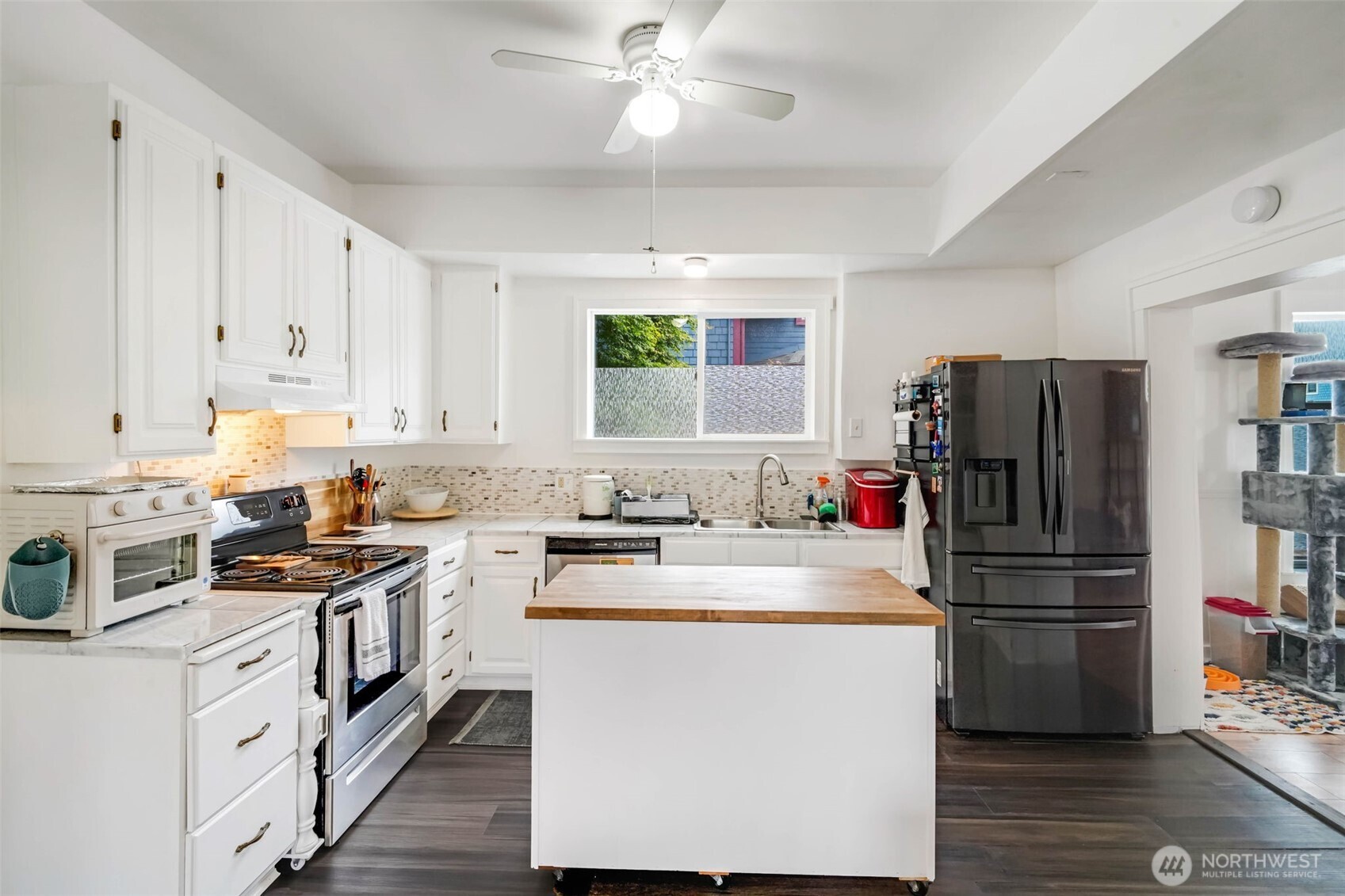 1224 4th Street Cosmopolis, WA 98537 - Photo 8 of 25 a kitchen with a refrigerator a stove cabinets and a center island