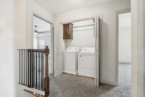 a view of a hallway with closet and utility room