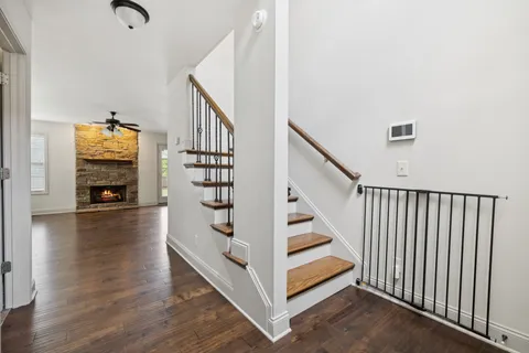 a view of entryway and hall with wooden floor