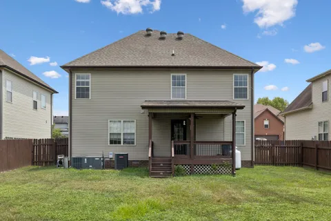 a view of a house with a yard and sitting area