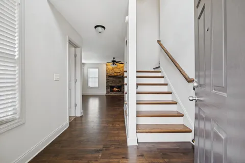 a view of an entryway with wooden floor