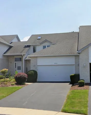 a front view of a house with a lake view