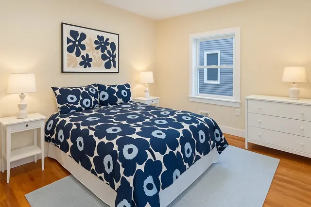 a large bed sitting in a bedroom next to a window