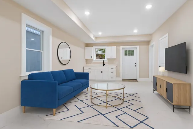 a living room with furniture and a flat screen tv