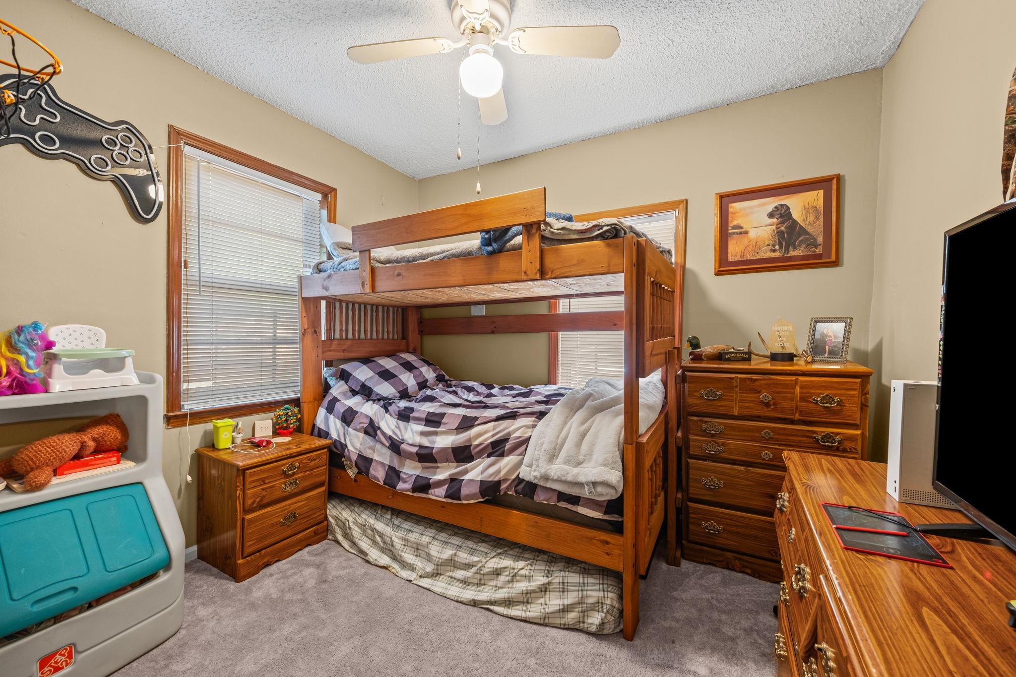 4140 Pleasant Ridge Road Millington, TN 38053 - Photo 21 of 30 Bedroom featuring light carpet, multiple windows, a textured ceiling, and a ceiling fan