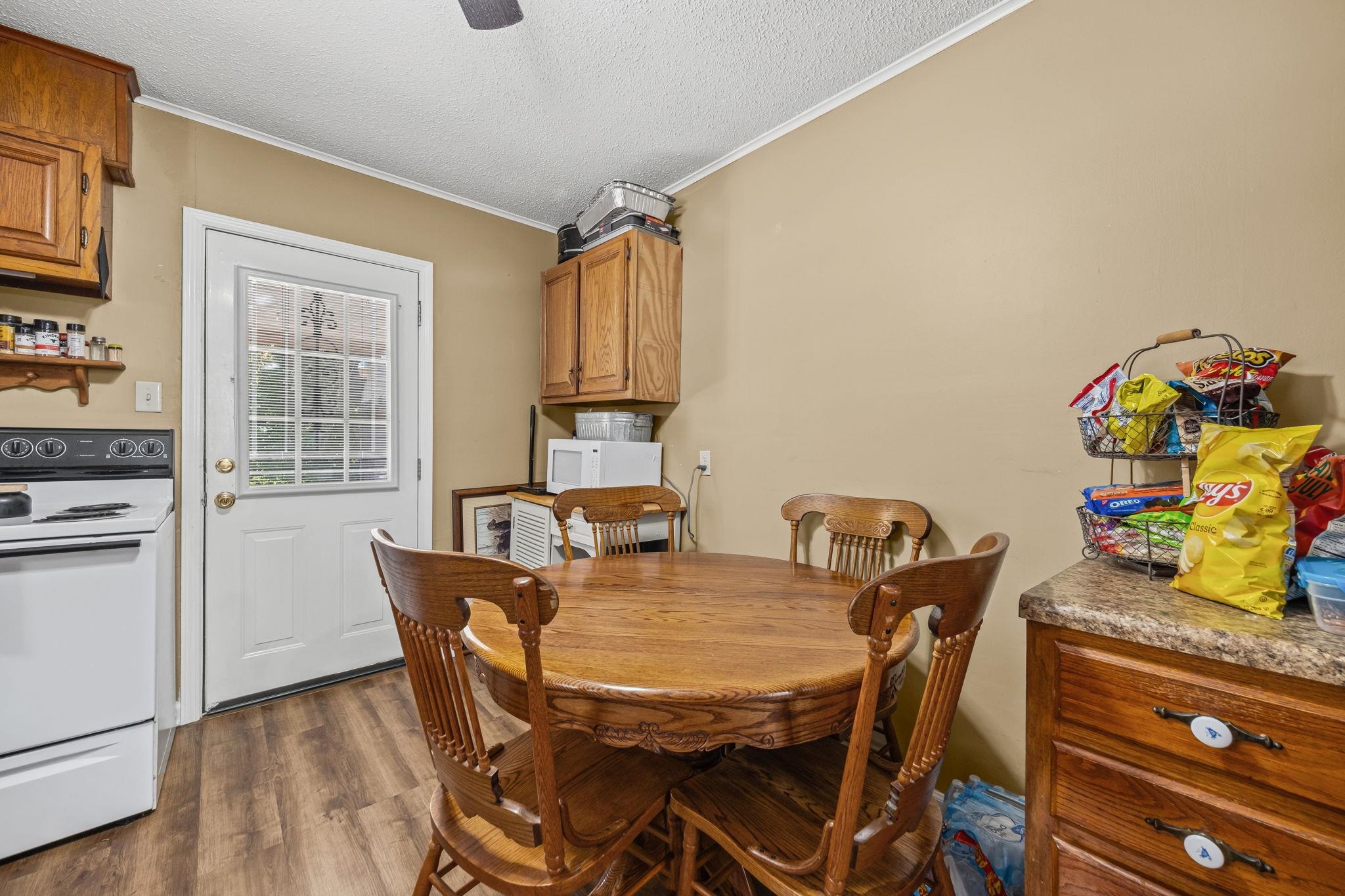 4140 Pleasant Ridge Road Millington, TN 38053 - Photo 6 of 30 Dining room with ornamental molding, dark wood finished floors, a textured ceiling, and ceiling fan