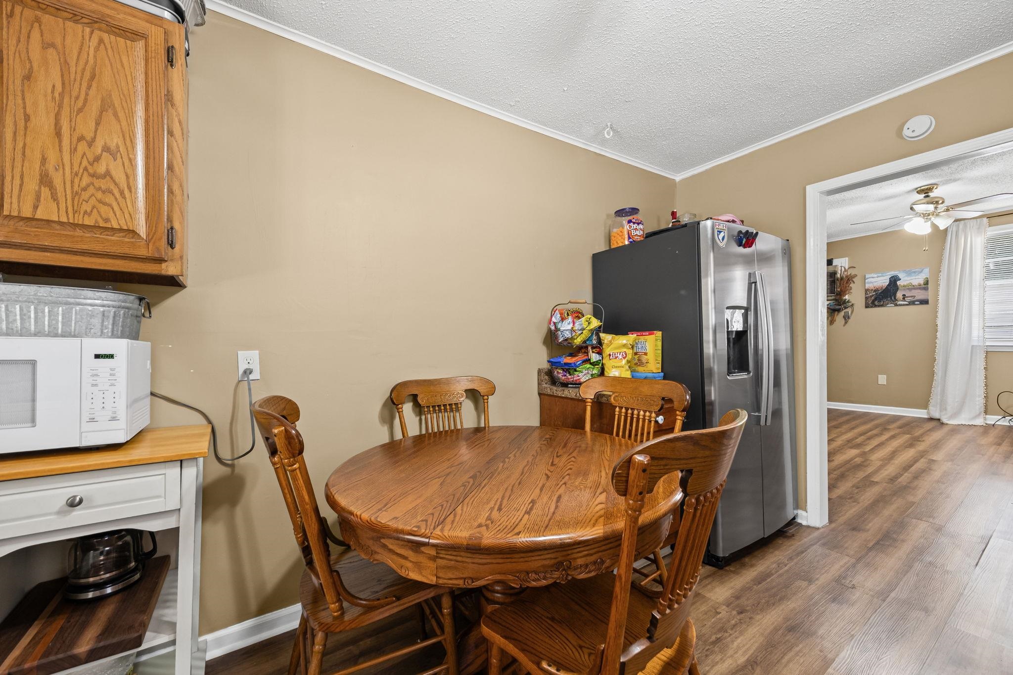 4140 Pleasant Ridge Road Millington, TN 38053 - Photo 7 of 30 Dining room with ornamental molding, dark wood finished floors, a ceiling fan, and a textured ceiling
