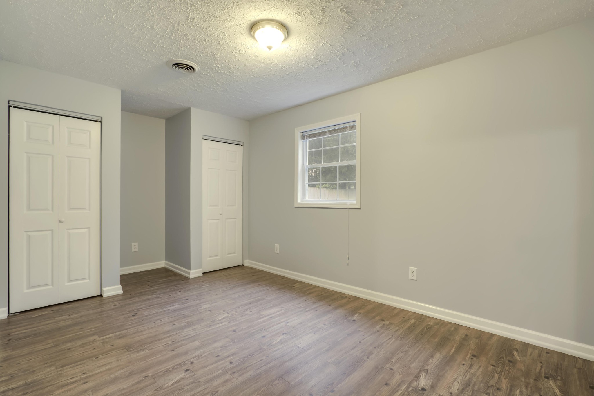 7604 Ogg Road Knoxville, TN 37938 - Photo 18 of 39 an empty room with wooden floor and windows