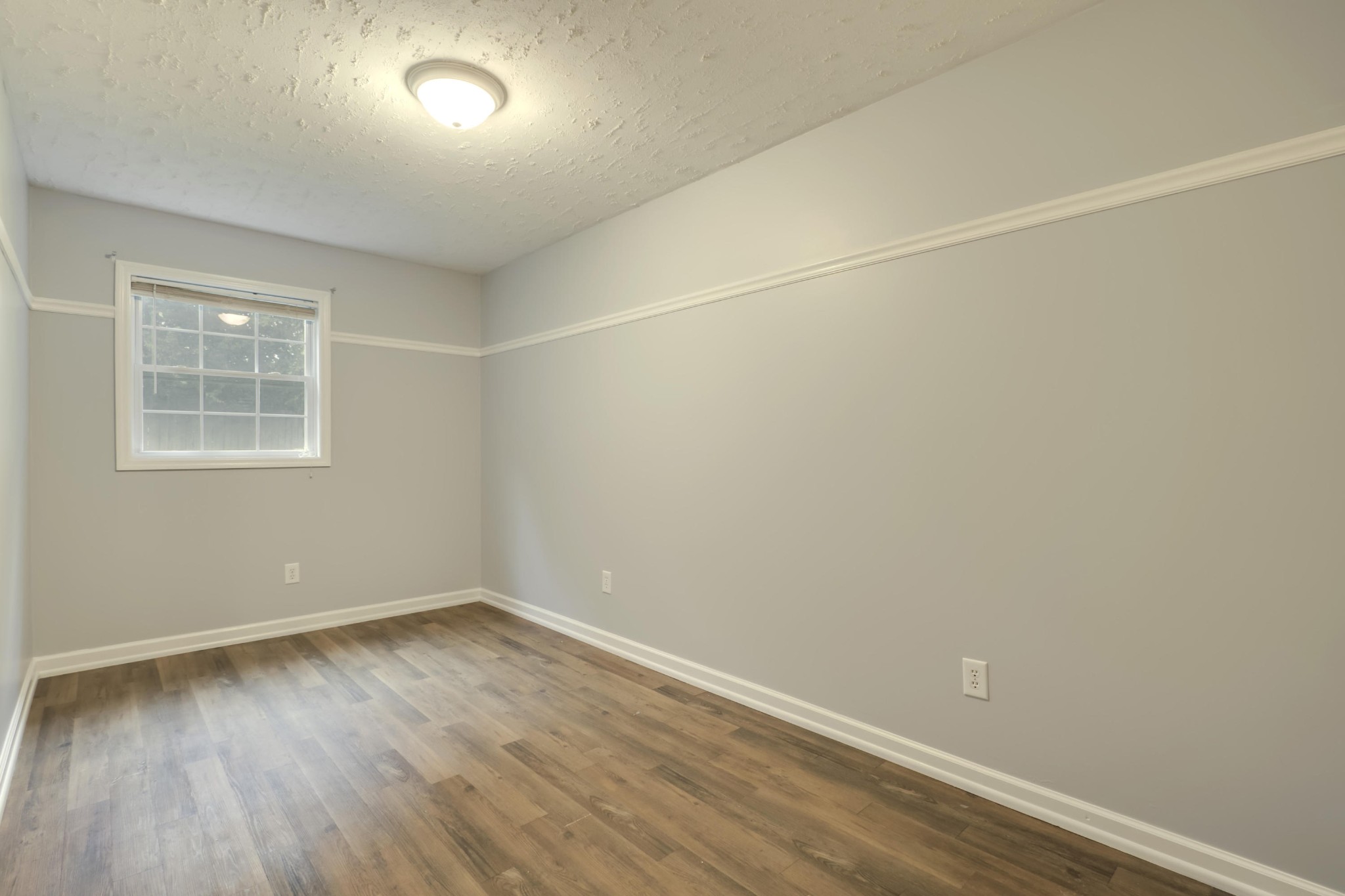 7604 Ogg Road Knoxville, TN 37938 - Photo 20 of 39 an empty room with wooden floor and windows