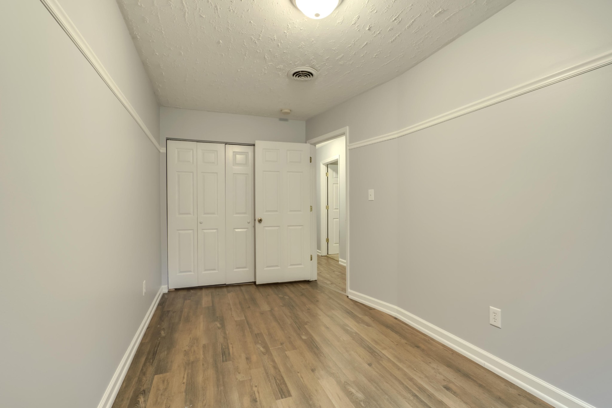 7604 Ogg Road Knoxville, TN 37938 - Photo 21 of 39 a view of a room with wooden floor and white walls
