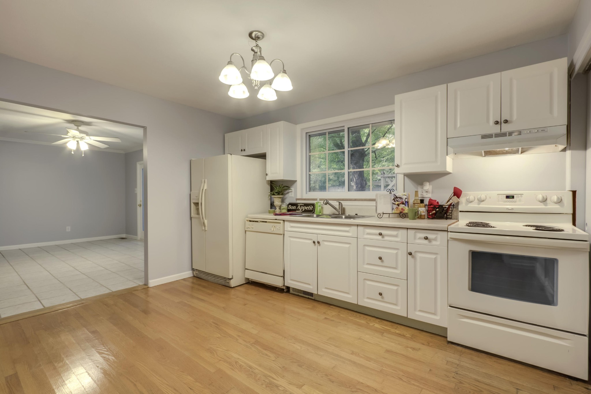 7604 Ogg Road Knoxville, TN 37938 - Photo 22 of 39 a kitchen with granite countertop white cabinets stainless steel appliances and sink