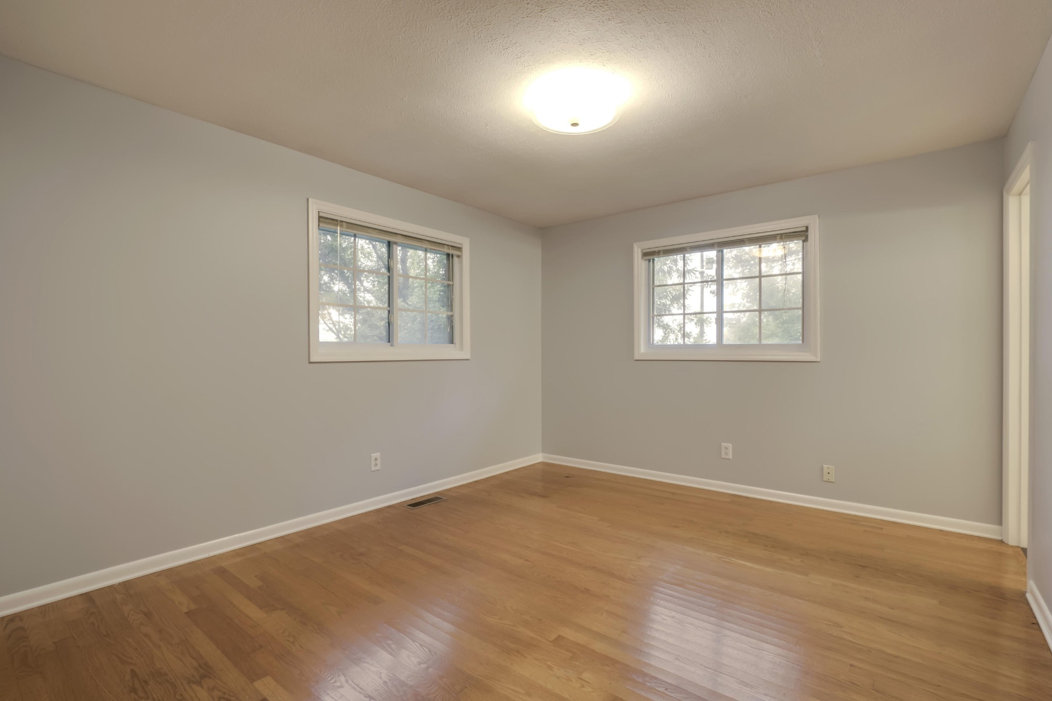 7604 Ogg Road Knoxville, TN 37938 - Photo 27 of 39 an empty room with wooden floor and windows