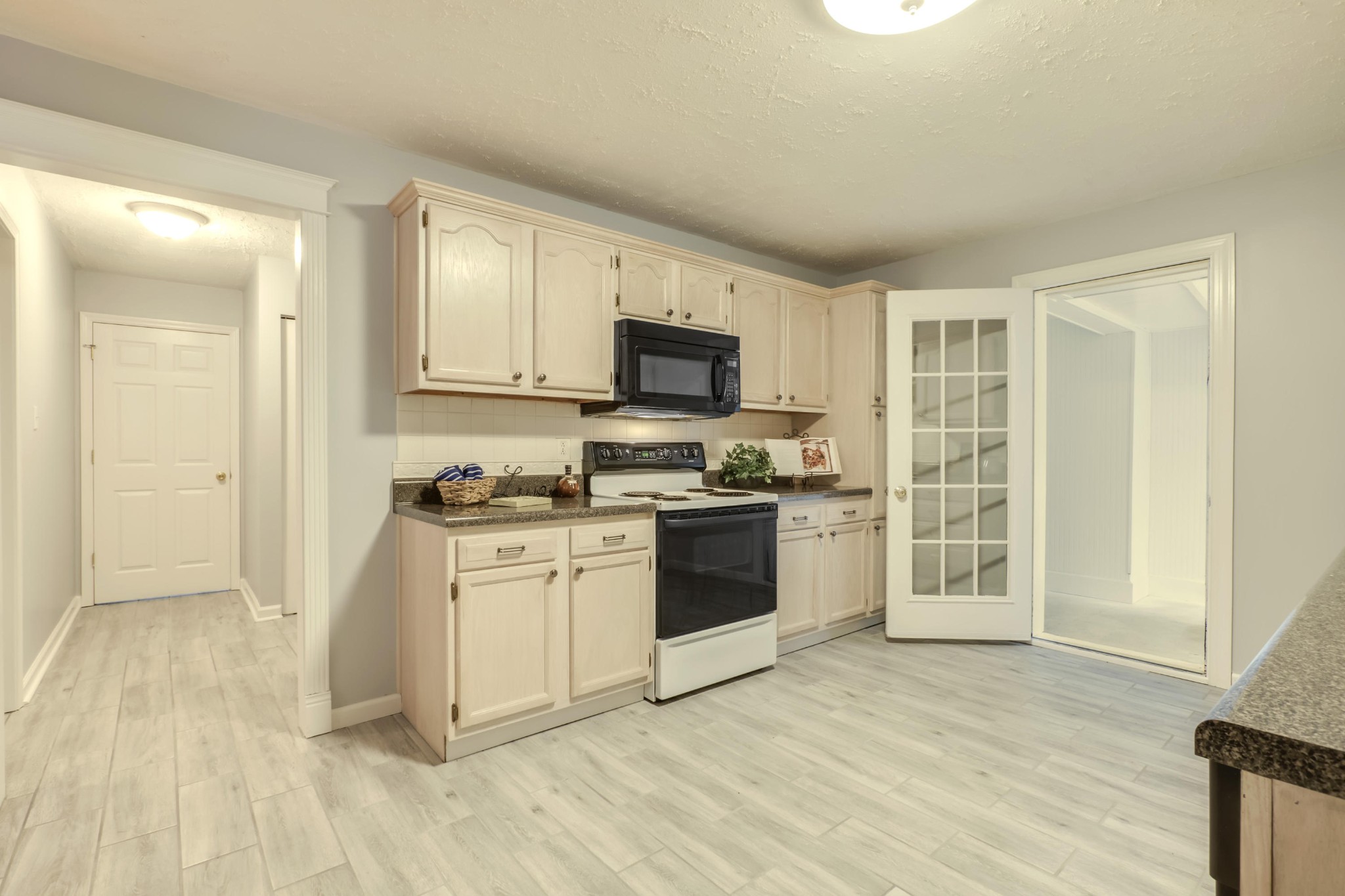 7604 Ogg Road Knoxville, TN 37938 - Photo 10 of 39 a kitchen with granite countertop a stove a sink and a refrigerator