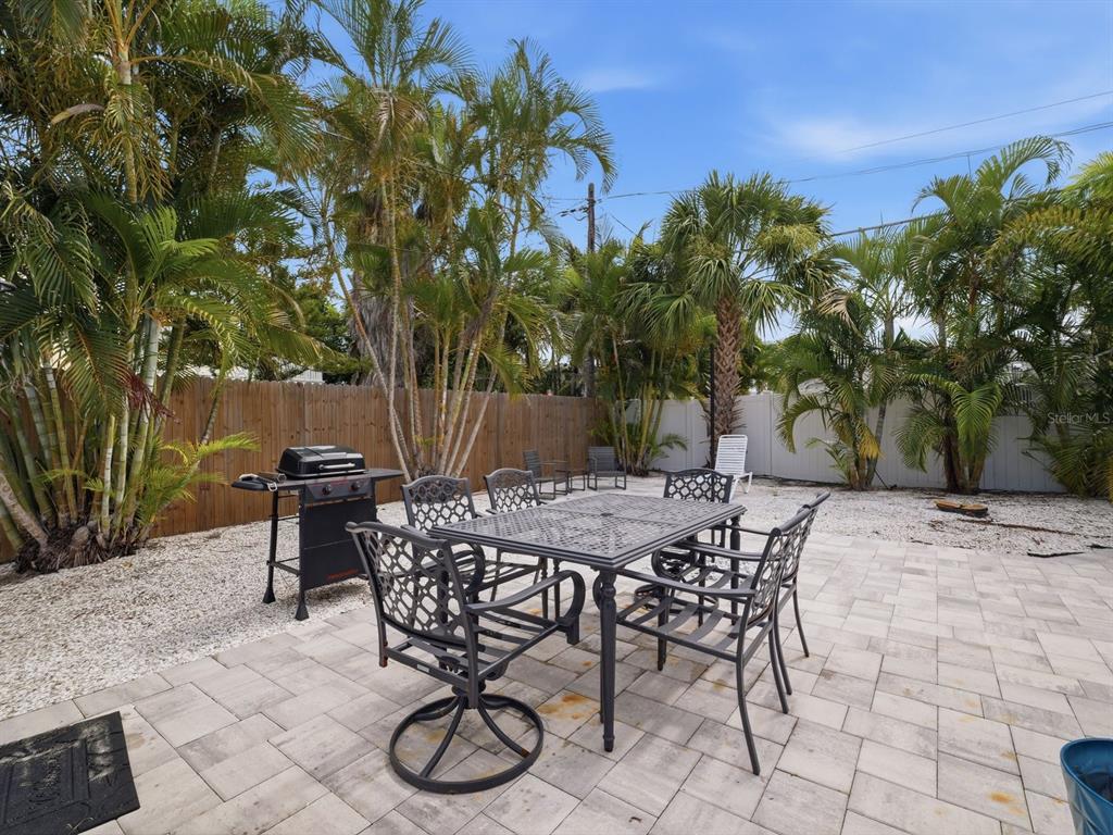 1207 1st Street Indian Rocks Beach, FL 33785 - Photo 33 of 60 a view of a backyard with furniture and a patio
